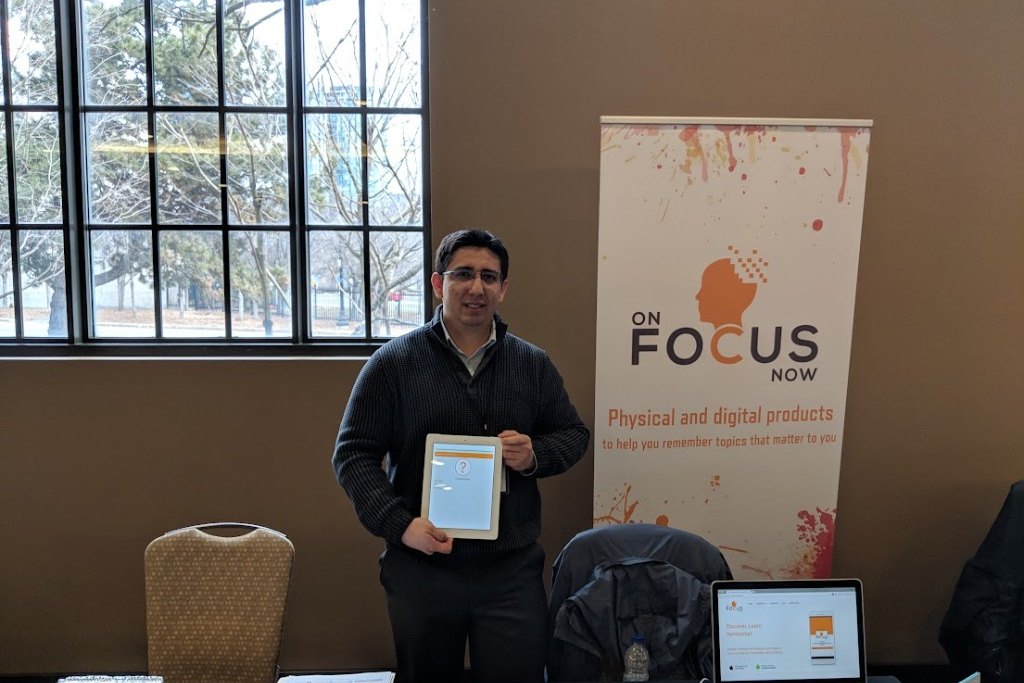 On Focus Now booth with banner and product demo